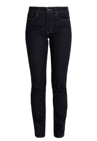 Jeans ajustados de mujer en azul marino oscuro con bolsillos delanteros y traseros, cierre de botón y costuras visibles.
