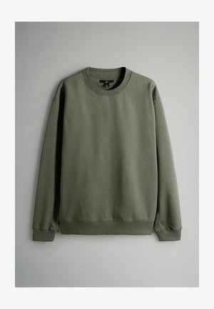 Grøn sweatshirt med rund hals, lange ærmer, ribbede manchetter og kant. Blød tekstur, enkelt design uden mønstre eller accenter.