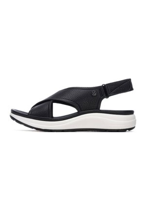 Sandalia de cuero negro con puntera abierta y laterales recortados, que cuenta con una suela acolchada blanca y una correa trasera ajustable para un ajuste seguro.