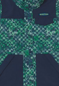 Green and navy patterned jacket featuring a hood, two front pockets, and a blue "Burton" logo patch on the chest. Textured fabric.