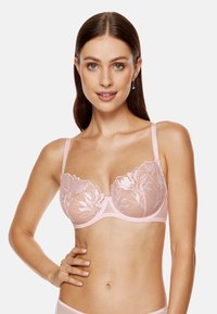 Różowy koronkowy biustonosz z haftem w kwiaty, przezroczyste miseczki, regulowane ramiączka i gładki pas. Zaprojektowany dla wsparcia i komfortu.