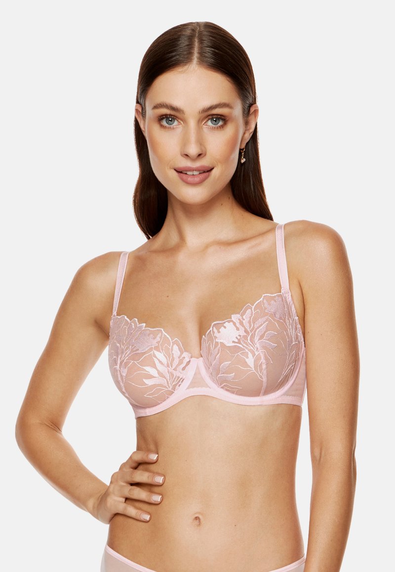 Różowy koronkowy biustonosz z haftem w kwiaty, przezroczyste miseczki, regulowane ramiączka i gładki pas. Zaprojektowany dla wsparcia i komfortu.
