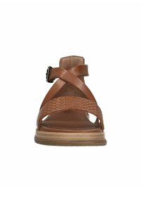 Brown leather sandal with woven strap detail, cross-over design, adjustable ankle buckle, and a light-colored flat sole.