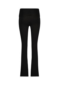 Svarta utsvängda leggins med en bred midjeband, med en samlad textur upptill. Slitstarkt, elastiskt tyg utan synliga mönster.