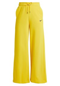 Gula vida sweatpants i mjukt tyg, med ett elastiskt midjeband och dragsko samt en liten svart logotyp på sidan.