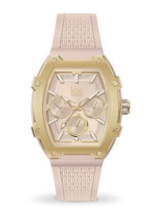 Montre avec un bracelet en silicone rose et un cadran octogonal doré, un cadran texturé rose clair et trois sous-cadrans pour les fonctionnalités de date et d'heure.