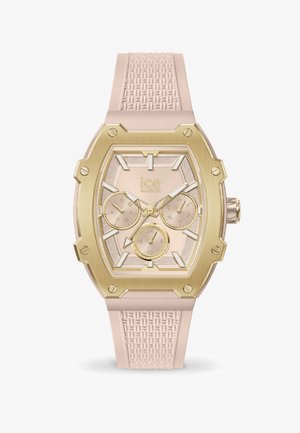 Montre avec un bracelet en silicone rose et un cadran octogonal doré, un cadran texturé rose clair et trois sous-cadrans pour les fonctionnalités de date et d'heure.