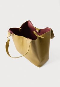 Olivově zelená kožená taška přes rameno s texturovaným povrchem, tmavě vínovou podšívkou a odnímatelným páskem. Disponuje magnetickým zapínáním a dvojitými držadly.