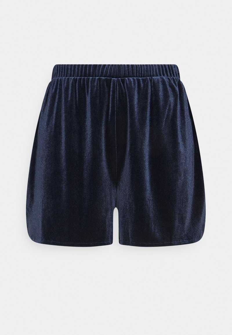 Shorts en velours bleu foncé avec taille élastique, tissu froncé et coupe ample sur un fond uni gris clair.