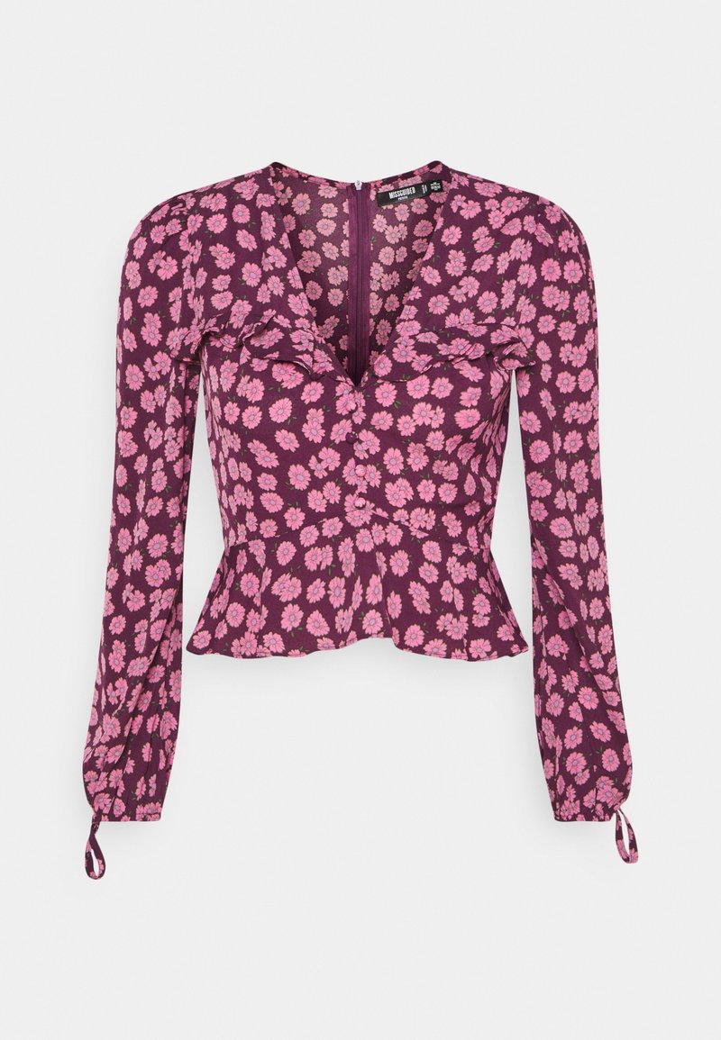 Blouse violette à manches longues avec imprimé floral rose, col en V, détail volants sur la poitrine, taille peplum et poignets à nouer.