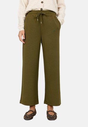 Olivegrüne, weit geschnittene Sweatpants aus weichem Material mit elastischem Bund und Kordelzug. Mit Seitentaschen und lockerer Passform.