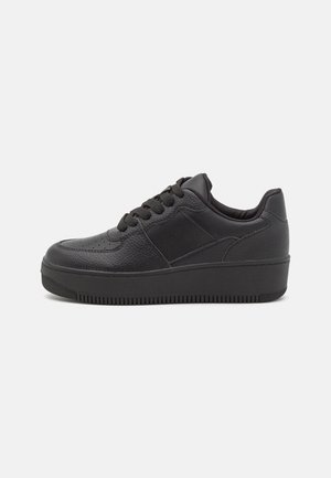 Black leather sneakers with textured upper, round toe, flat laces, rubber sole, and subtle stitching details on the sides.