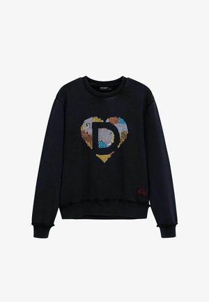 Sudadera negra con un corazón bordado a color con una 'D' en el centro. Cuello redondo y puños acanalados, ajuste holgado, textura suave.