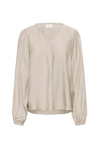 Blouse beige claire avec un col en V, manches longues, poignets froncés et coupe décontractée, fabriquée dans un tissu texturé et doux.