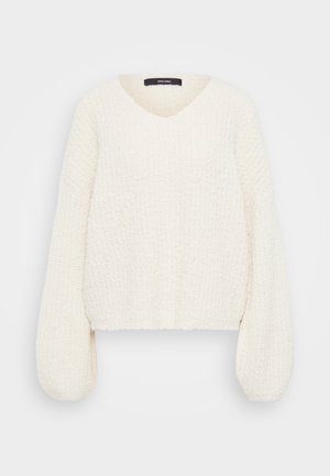 Pull en tricot blanc avec un col en V, des manches bouffantes longues et une finition en relief. La coupe courte met en valeur l'ajustement ample et confortable.