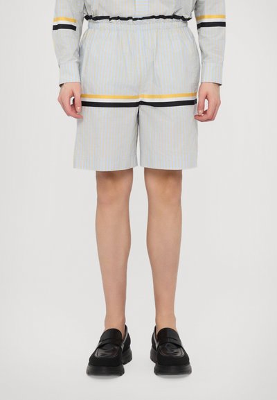 Blå og beige stripete shorts med elastisk midje, med svarte og gule horisontale detaljer. Laget av lett stoff.