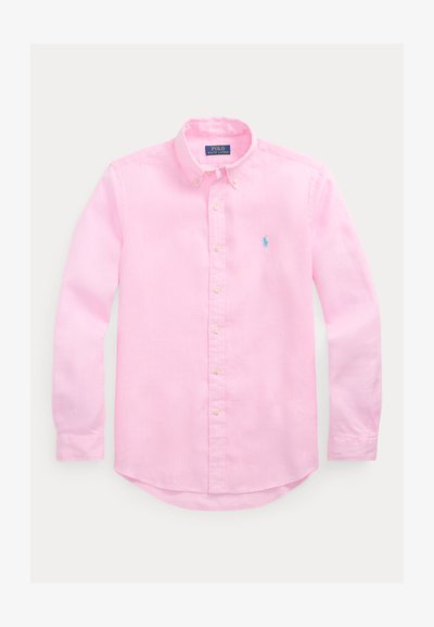 Világos rózsaszín, hosszú ujjú, gombos ing, gombos gallérral és a bal mellrészen kék Polo Ralph Lauren logóval hímzett.