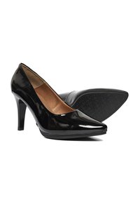 Zapatos de tacón alto de charol negro con punta afilada, tacón delgado y suela de goma texturizada. El interior presenta un forro marrón.