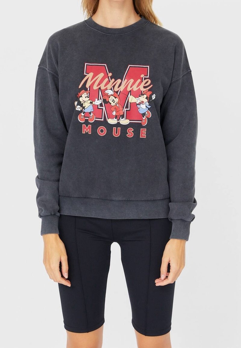 Donkergrijze sweatshirt met geribbelde manchetten en zoom, met een kleurrijke "Minnie Mouse"-afbeelding en karakters in rood en wit.
