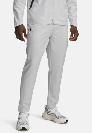 UA UNSTOPPABLE TAPERED - Tracksuit bottoms - halo gray