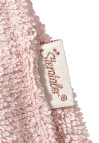 Pink terry cloth fabric features a textured surface. A white label with "Stendhal" is visible, adorned with a rose gold embroidered logo.
