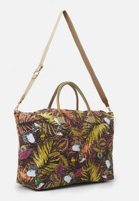 Kangaskassi, jossa on eläväinen viidakon kuvio ja sarjakuvahahmoja. Sisältää lyhyet kantokahvat ja irrotettavan olkahihnan.