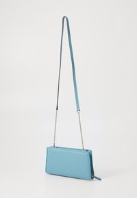 Blue vegan leather crossbody bag with a rectangular shape, a smooth texture, and a detachable chain and strap for versatile carrying options.