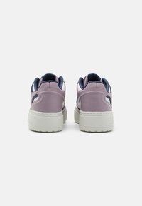 Pair of purple and navy sneakers with white soles, viewed from the back on a plain white background.