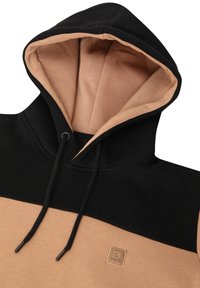 Felpa con cappuccio realizzata in tessuto morbido, con una parte superiore nera, parte inferiore beige, cordini regolabili e una patch con logo.