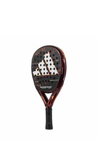 Padel racket with a black and red design, featuring a textured surface, multiple perforations, and a rubber grip with a speckled pattern.