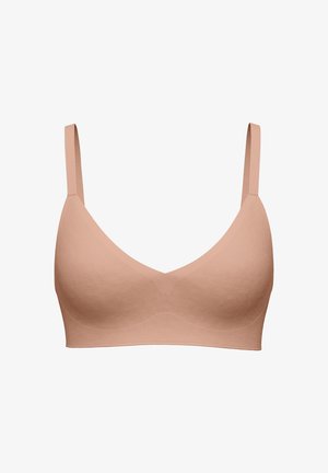 Reggiseno wireless color nudo senza cuciture, con spalline sottili regolabili e coppe modellate lisce, progettato per il comfort e l'uso quotidiano.