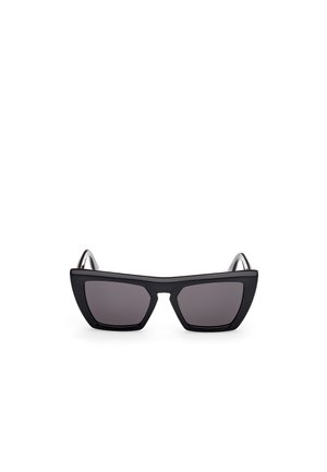 Black cat-eye sunglasses with dark lenses, featuring a thick, matte plastic frame and angular temples, designed with a minimalist aesthetic.