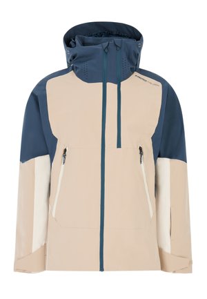Beige en marineblauwe waterdichte jas met een hoge kraag, verstelbare capuchon, twee ritszakken en contrasterende kleurvlakken.