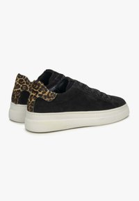 Black suede sneakers with a leopard-print fur heel accent and white rubber sole; features black laces and padded tongue.