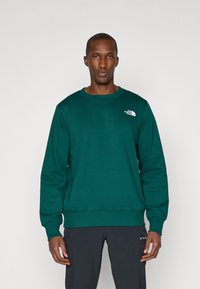 Green sweatshirt made of cotton blend, featuring a crew neck, long sleeves, ribbed cuffs, and a small white logo on the left chest.