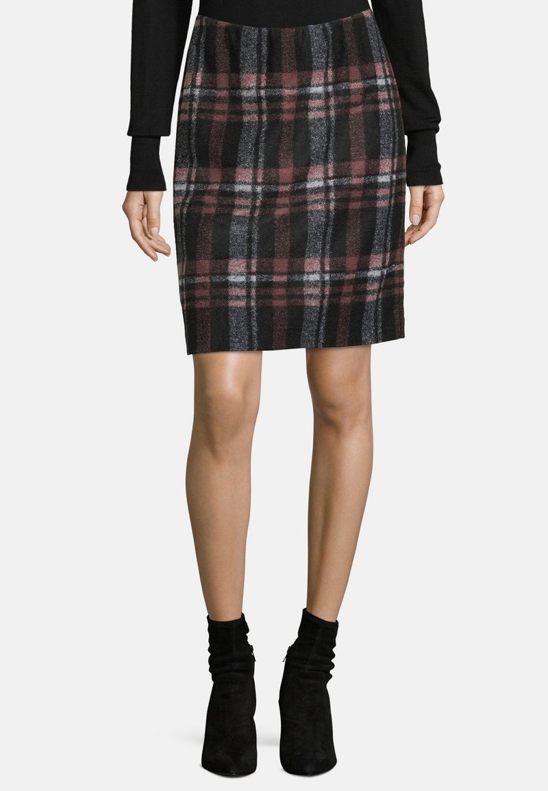 Rutiga kjolen i svart, vinröd och grå; knälång stickad med elastisk midja; matchad med svarta ankelstövlar.