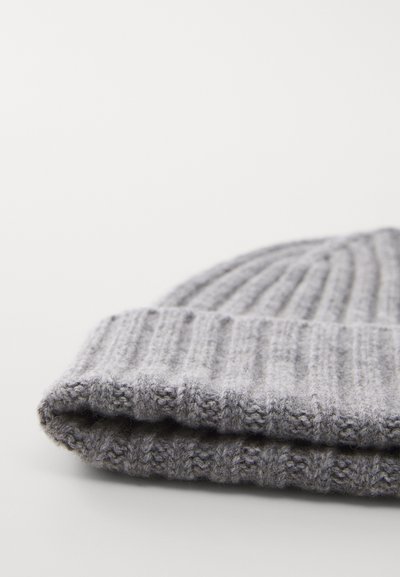 Gray knitted beanie with a ribbed texture. Features a rolled-up cuff and soft, fuzzy wool material.