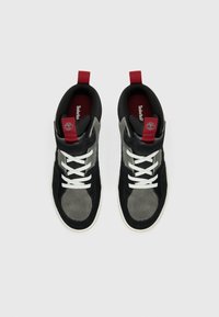 Black and gray suede and textile high-top sneakers with white laces, a red accent pull tab, and contrasting logo on the insole.