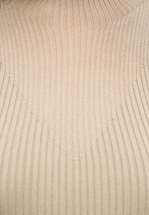 Tessuto a maglia beige con motivo a spina di pesce formato da linee verticali e diagonali.