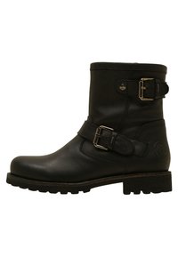 Bottines en cuir noir avec un léger talon, dotées d'une sangle à boucle réglable et d'une semelle en caoutchouc texturée. Fini lisse, design à bout rond.