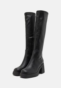 Black knee-high boots made of smooth leather with a block heel and a side zipper. Features a rounded toe and minimal stitching details.