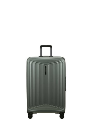 Medium-sized gray hard-shell suitcase with telescoping handle and four spinner wheels, featuring a ridged rectangular design on the front.