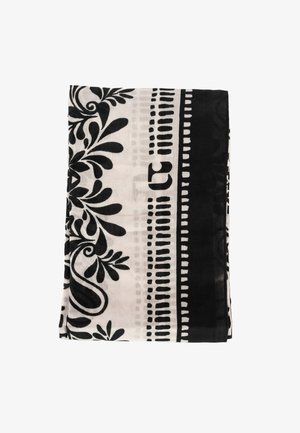 Tessuto piegato con motivi floreali e geometrici in bianco e nero su sfondo chiaro e bordatura nera uniforme.