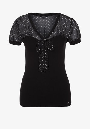 Zwart topje met korte mouwen en geribd lijfje, doorschijnende pofmouwen met polkadots, V-halslijn en bijpassend polkadot strikdetail middenvoor.