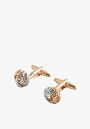 Paar Manschettenknöpfe mit gedrehtem Knoten-Design in Roségold- und Silbertönen mit strukturierter Details auf weißem Hintergrund.