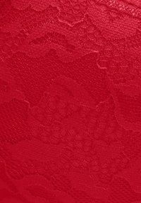 Red lace fabric featuring a textured floral pattern with subtle variations in weave, providing depth and dimension to the surface.