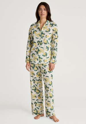 Long-sleeve pajama set in soft fabric, featuring a lemon and leaf pattern in yellow and green on a light background. Loose-fit pants.