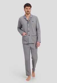 Conjunto de pijama de punto gris con acentos azules, que incluye una parte superior con botones y dos bolsillos frontales, y pantalones ajustados a juego. Textura suave, ligero.