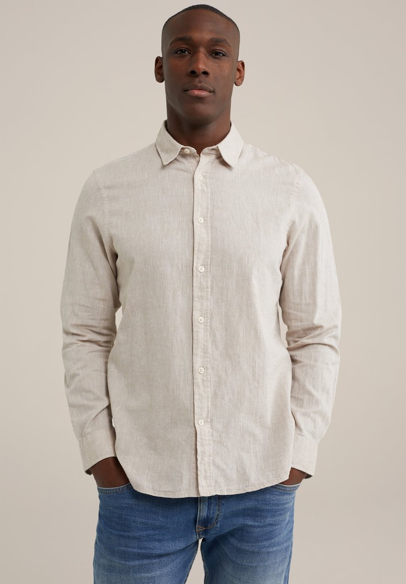 Light beige long-sleeve shirt with a button-down collar and front buttons. Made of textured fabric, worn with blue jeans.