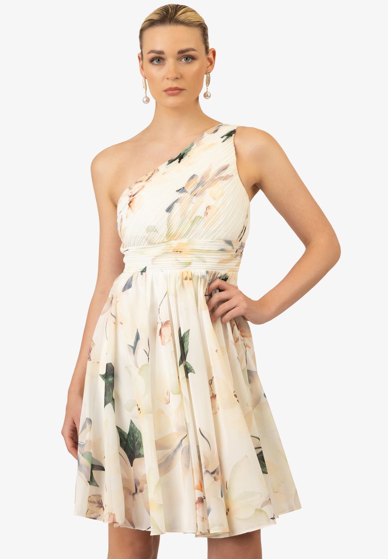 Cremfarbendes, einseitiges Blumenkleid mit plissiertem Rock, weichem Textil und bunten, pastellfarbenen Blumendrucken.